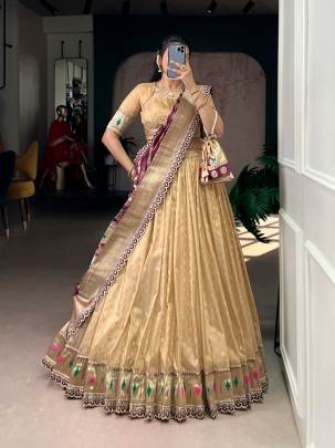 This shimmer organza lehenga choli adorned with zari weaving and delicate lace borders brings timeless elegance to every festive moment LNB2032CRM